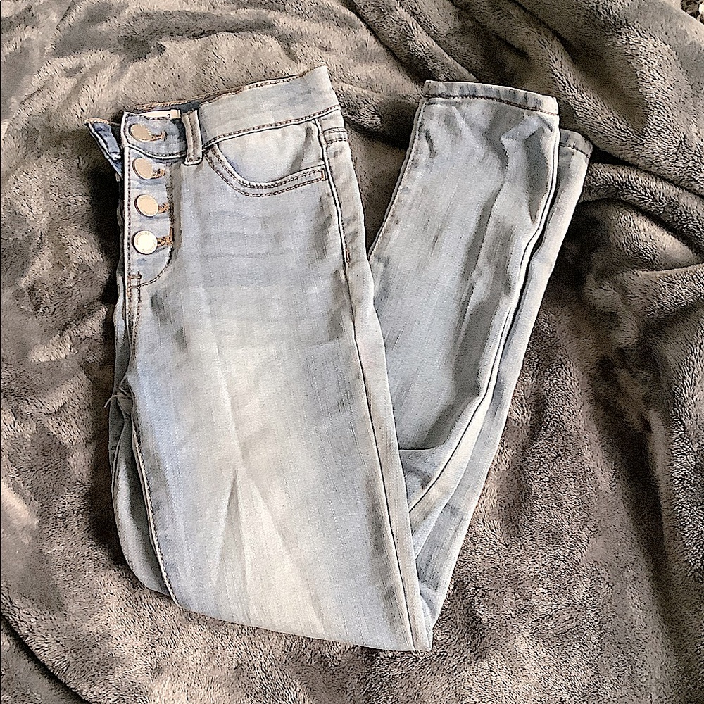 These are regular jeans with no rips in them and have 4 buttons on them.
